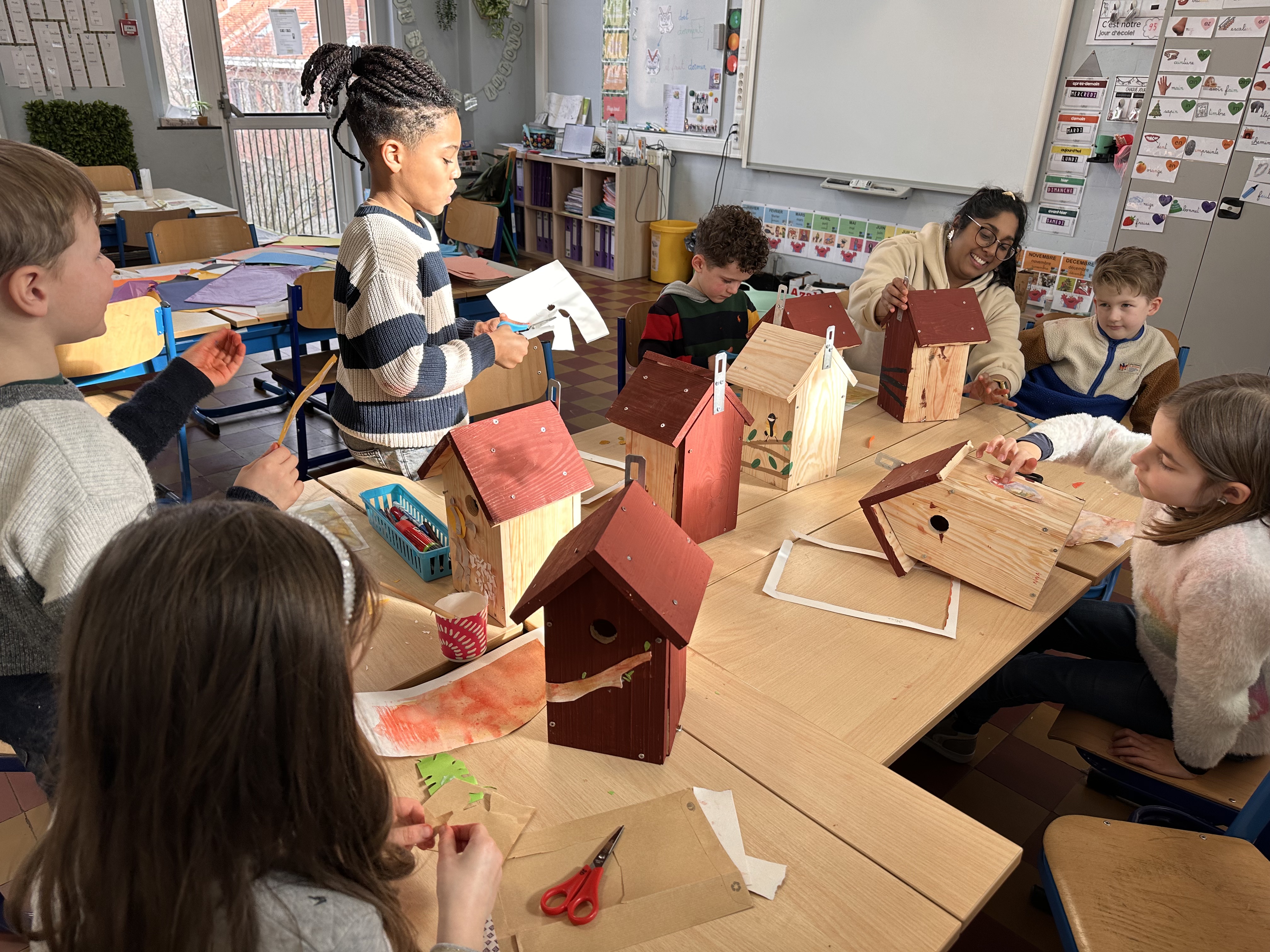 Six enfants de 2ème primaire du CSM décorent leurs nichoirs assemblés en atelier créatif